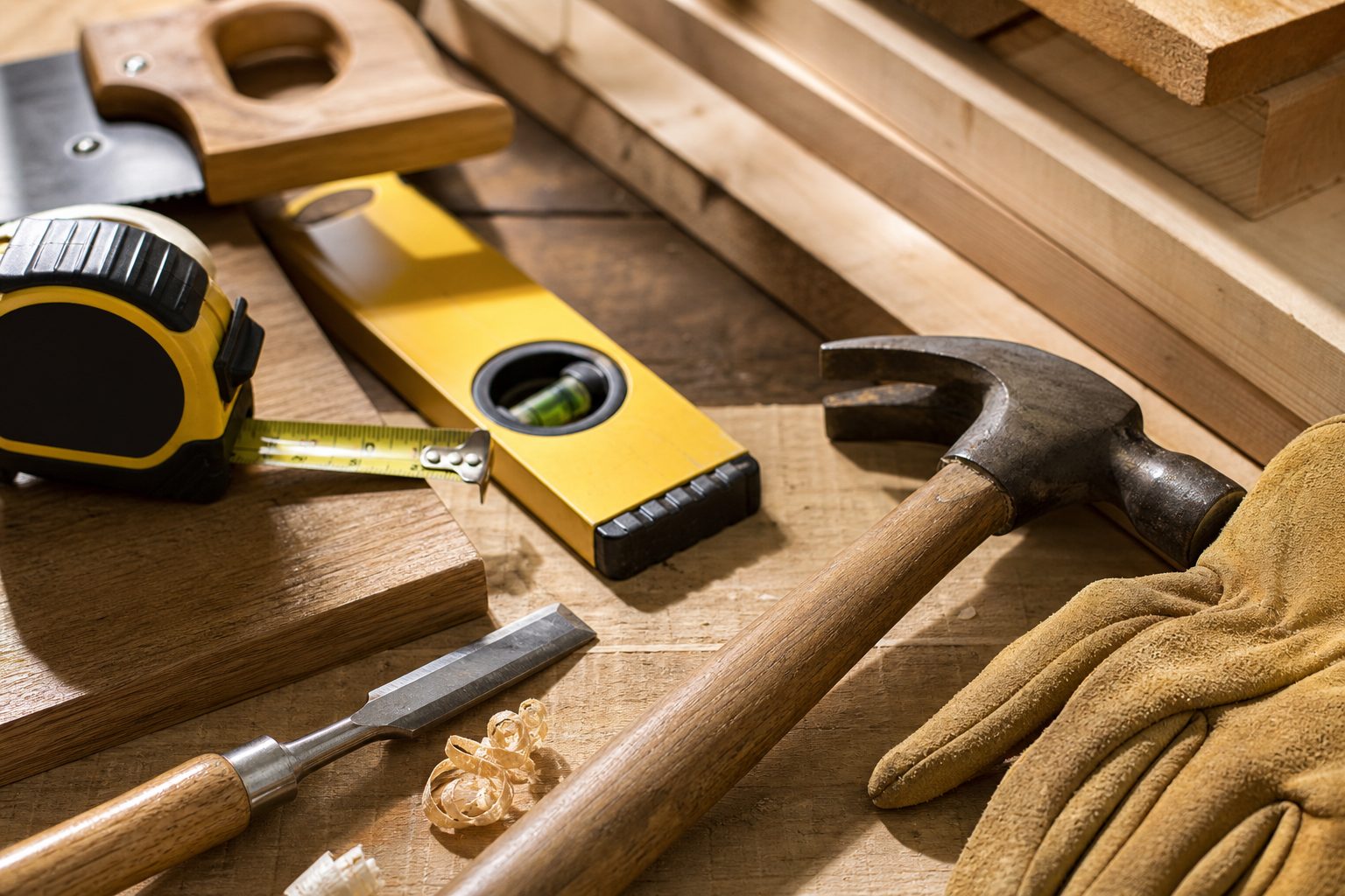 Concept image of carpentry tools laid out on raw wood